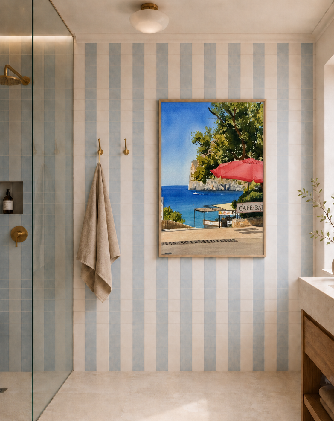 Framed Watercolour artwork of a seaside café bar in a striped tiled bathroom