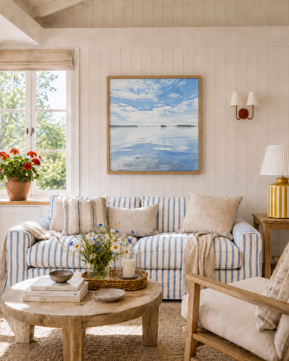 Framed Watercolour artwork of the archipelago above a striped sofa in a summer cottage